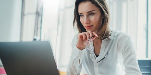 Business lady on laptop reviewing reports in CTM Smart Data