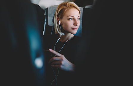 A woman looking out of an airplane window